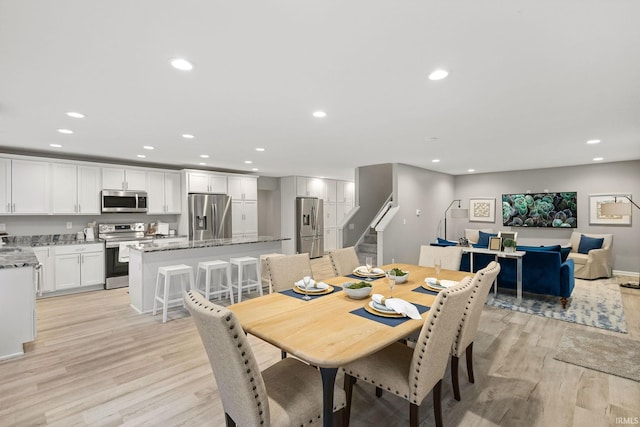 dining area featuring sink and light wood-type flooring