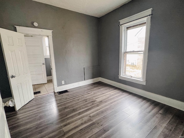 empty room featuring dark wood-type flooring