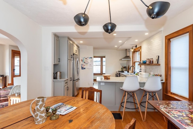 dining area with sink and light hardwood / wood-style floors