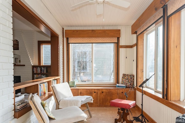 sunroom / solarium with plenty of natural light and ceiling fan