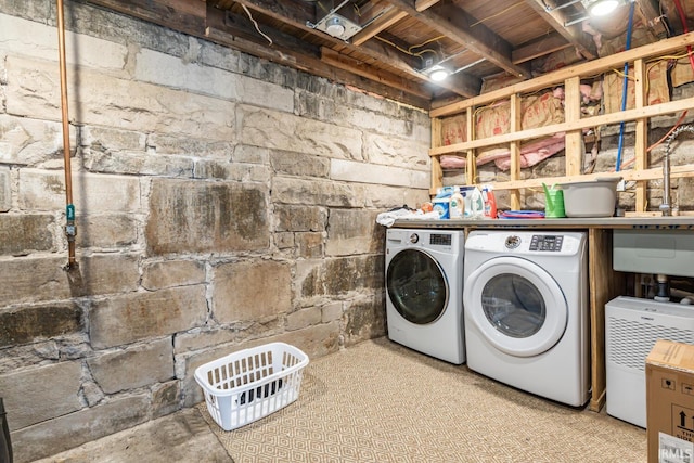 clothes washing area with washing machine and dryer