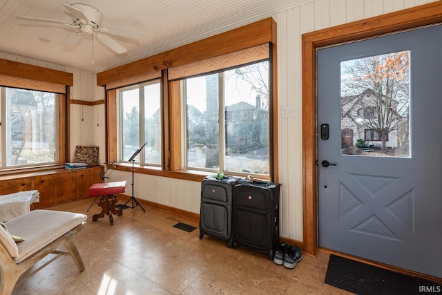 sunroom featuring ceiling fan