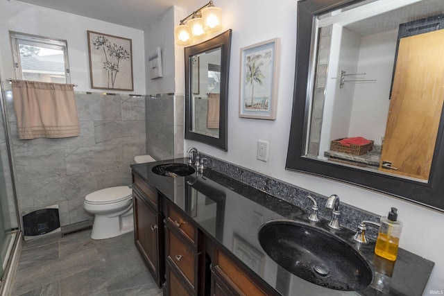 bathroom featuring vanity, toilet, and tile walls