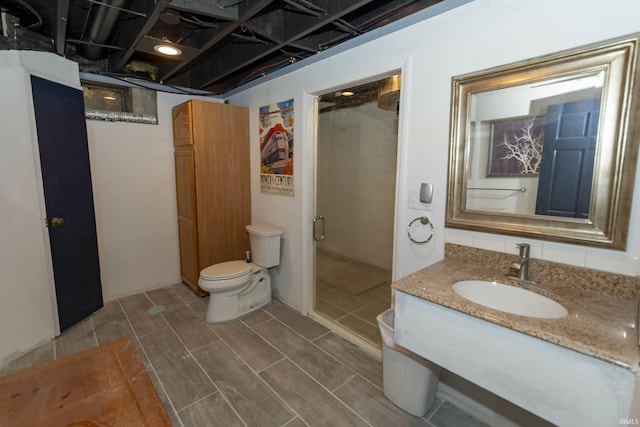 bathroom featuring vanity, toilet, and walk in shower