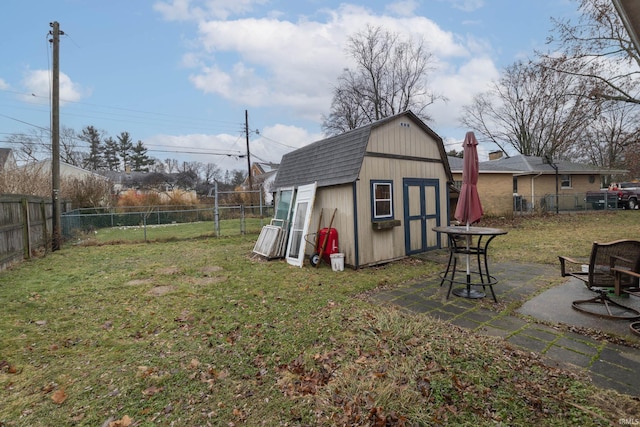 view of yard featuring a shed and a patio