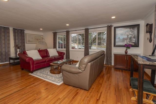 living room with ornamental molding and light hardwood / wood-style flooring