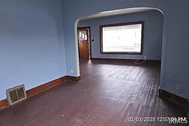 empty room with dark hardwood / wood-style flooring