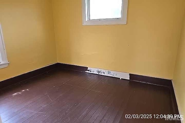 unfurnished room featuring hardwood / wood-style flooring