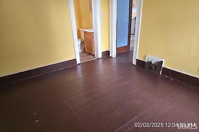 spare room with dark hardwood / wood-style flooring