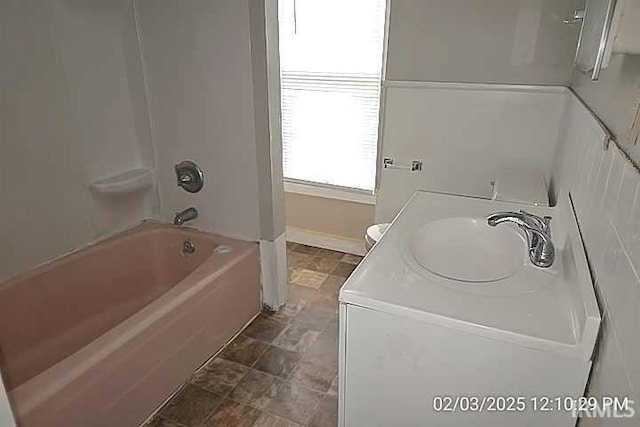 bathroom with toilet and tub / shower combination