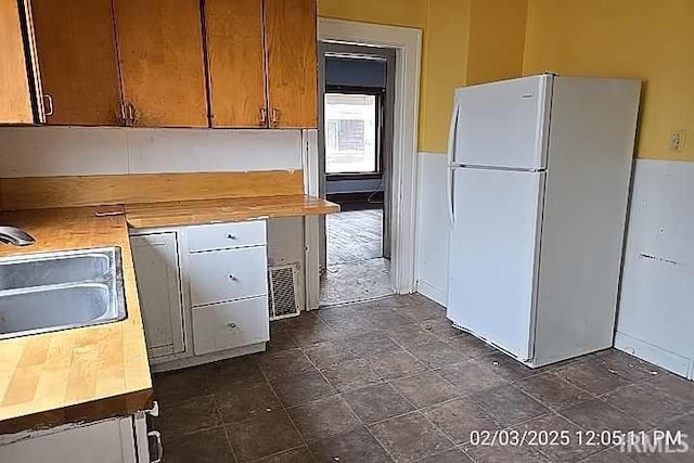 kitchen featuring sink and white refrigerator