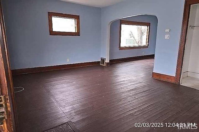 empty room with dark wood-type flooring