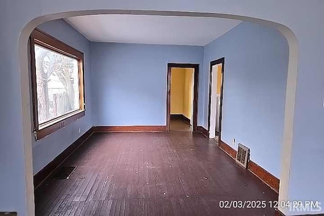 unfurnished room with dark hardwood / wood-style floors