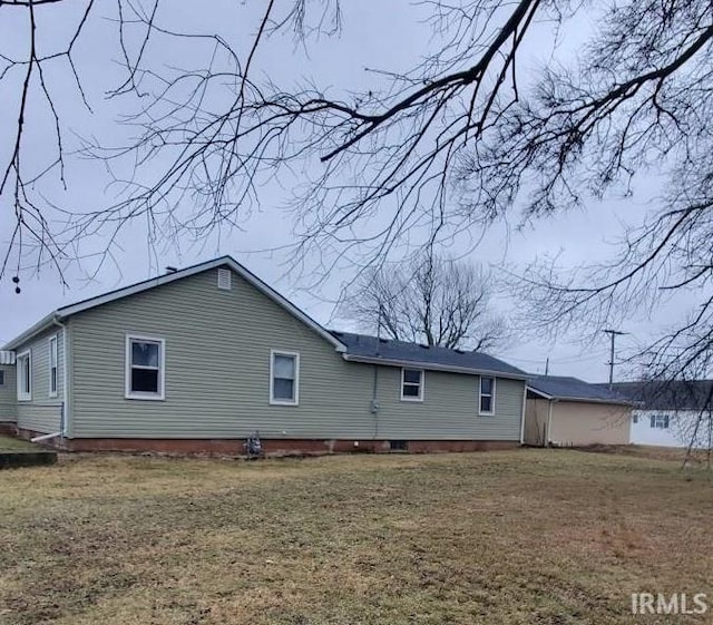 rear view of house with a lawn