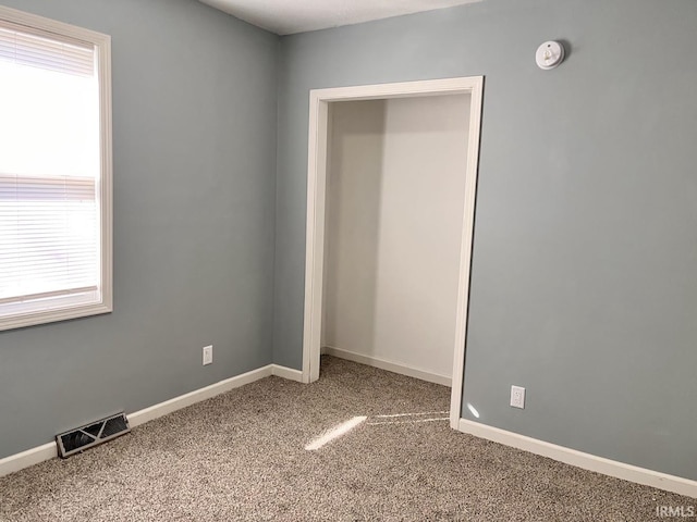 unfurnished bedroom featuring carpet