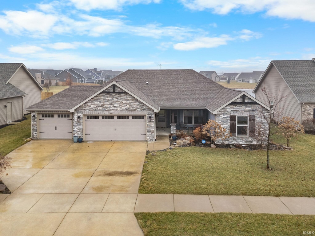 craftsman house featuring a garage and a front yard