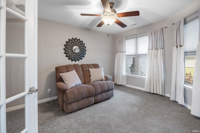 living room with carpet floors and ceiling fan