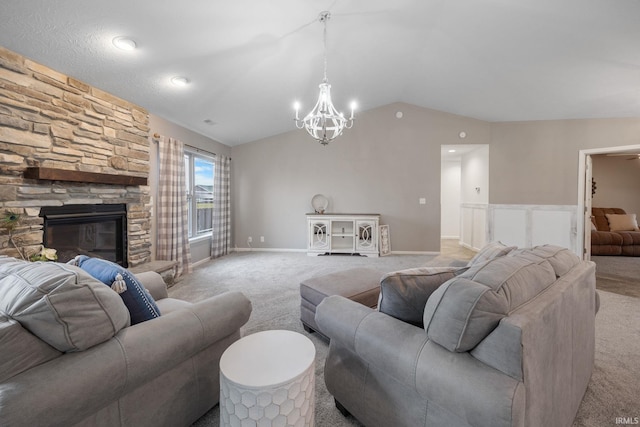 carpeted living room featuring a fireplace, vaulted ceiling, and a notable chandelier