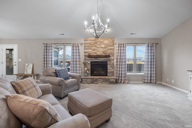 living room featuring light colored carpet, a stone fireplace, and a chandelier