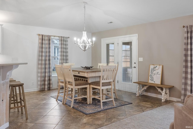 dining area featuring an inviting chandelier