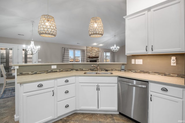 kitchen featuring a notable chandelier, sink, stainless steel dishwasher, and white cabinets