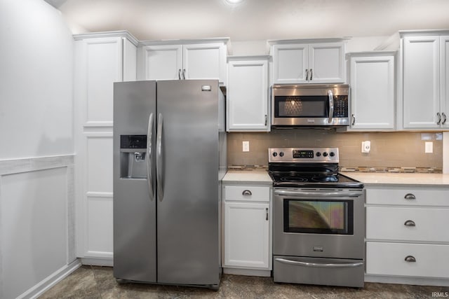 kitchen with white cabinetry, tasteful backsplash, and appliances with stainless steel finishes