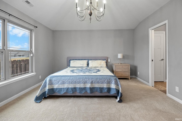 bedroom featuring carpet and an inviting chandelier