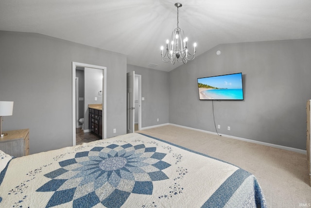 bedroom with an inviting chandelier, ensuite bath, vaulted ceiling, and carpet