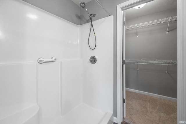 bathroom featuring a textured ceiling and a shower