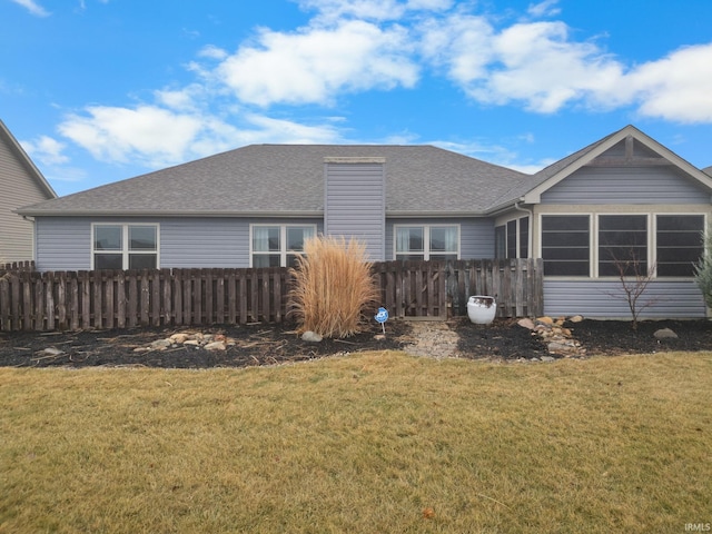 back of property featuring a yard and a sunroom