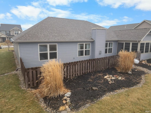 rear view of property featuring a yard