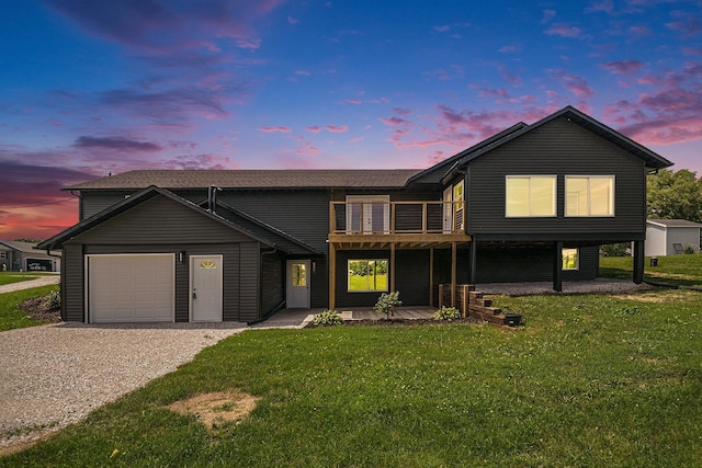 view of front of home with a garage and a lawn