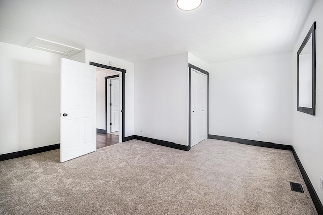 unfurnished bedroom with a closet, carpet floors, and a textured ceiling