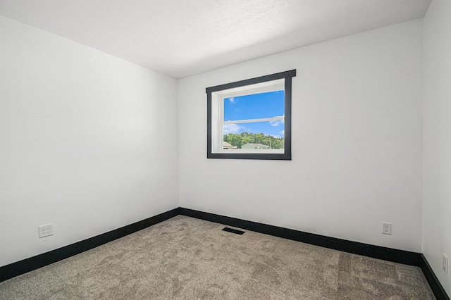 unfurnished room with carpet flooring