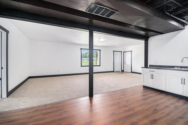 basement with sink and dark carpet