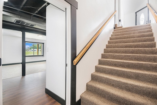 staircase featuring hardwood / wood-style flooring