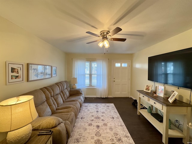 living room with ceiling fan and dark hardwood / wood-style flooring