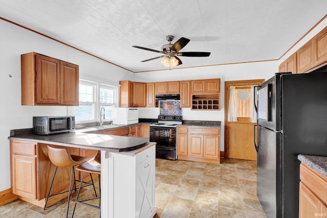 kitchen with a kitchen bar, sink, electric range, black refrigerator, and kitchen peninsula