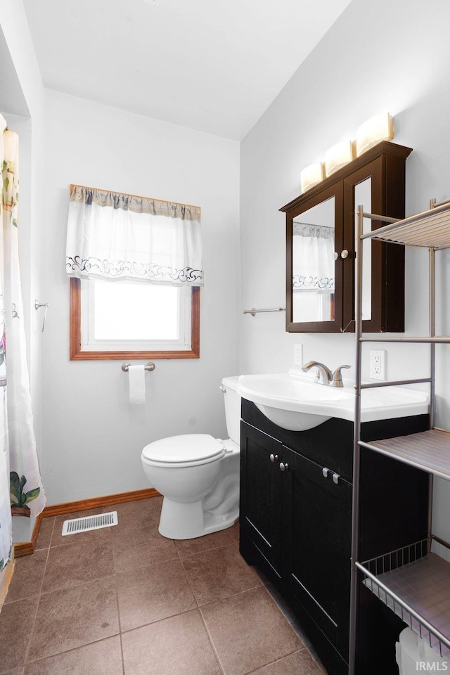 bathroom with tile patterned floors, vanity, and toilet