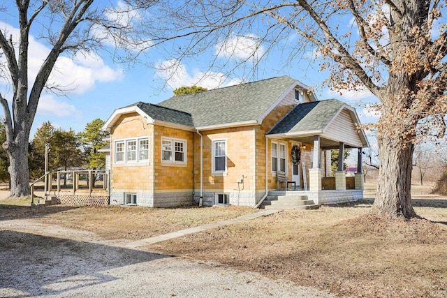 view of side of property with a porch