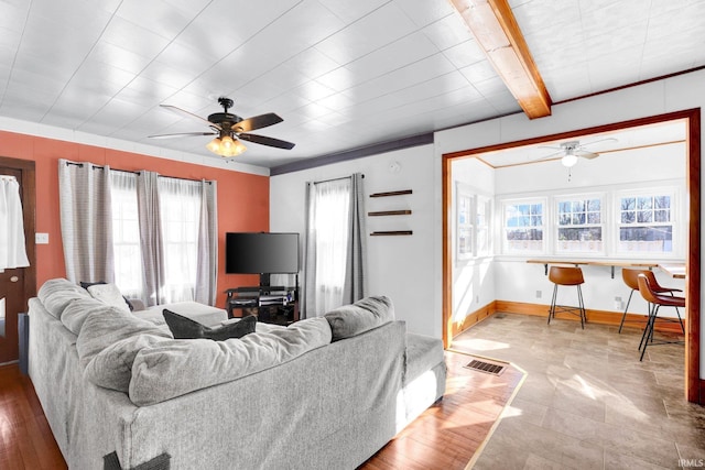 living room featuring beam ceiling and ceiling fan