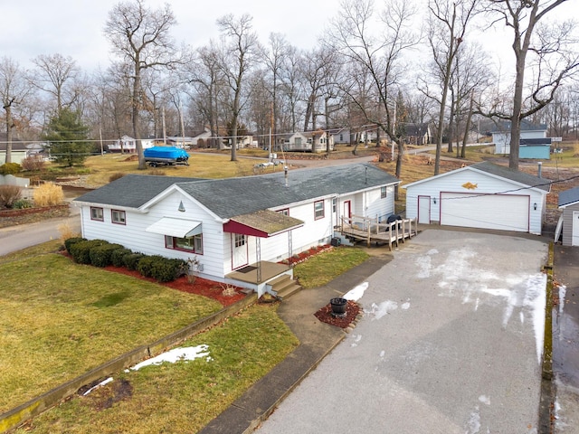 view of front of home with a garage, an outdoor structure, and a front lawn