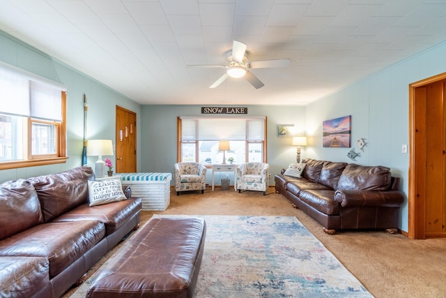 living room featuring ceiling fan, light colored carpet, and a wealth of natural light