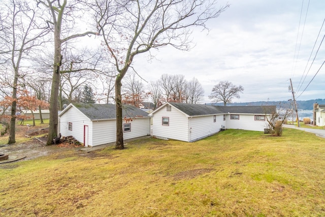 view of side of home with a lawn