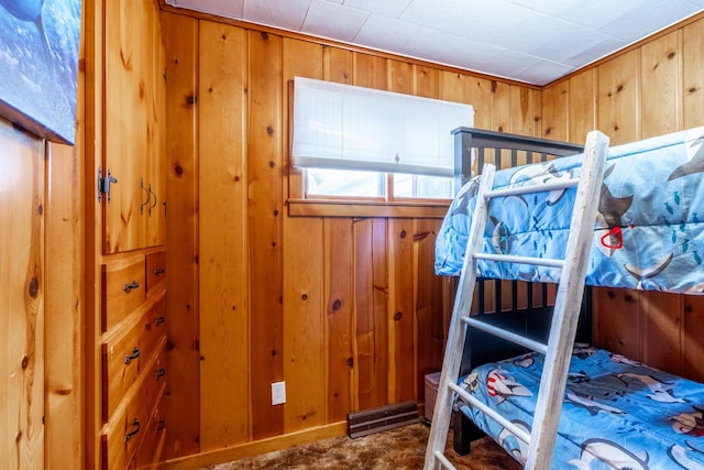 bedroom with wood walls