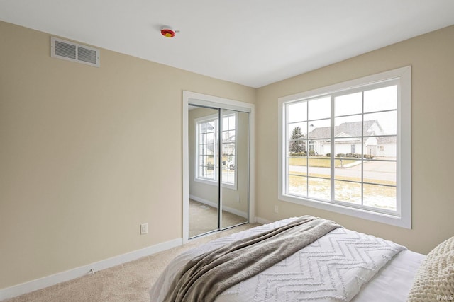 carpeted bedroom with a closet