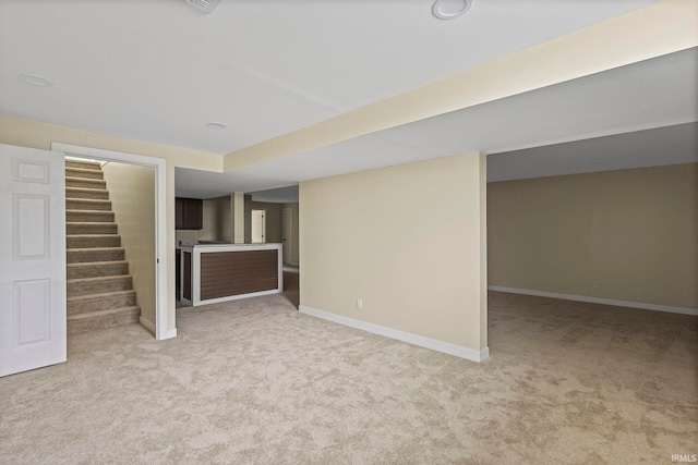 basement featuring light colored carpet