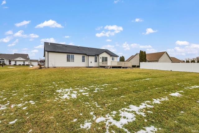 back of house with a yard and a deck