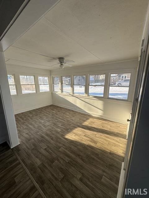 unfurnished sunroom featuring ceiling fan