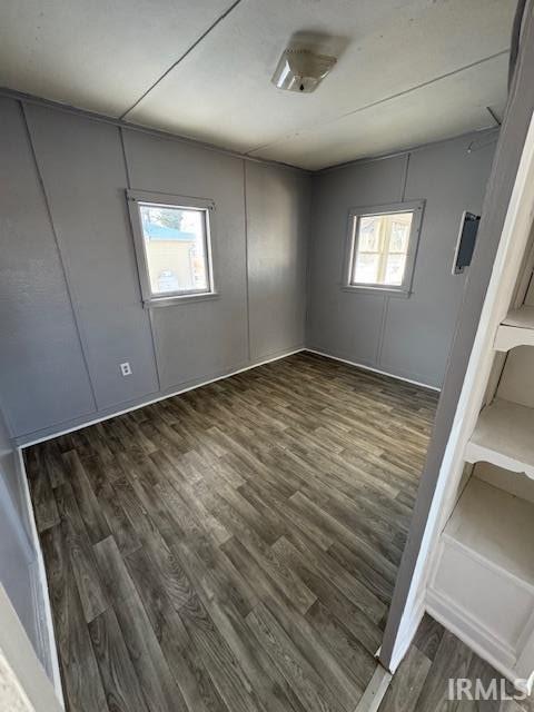 empty room with dark hardwood / wood-style floors